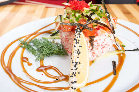 Salad, salmon tartare with caviar, on a plate. For any purpose.