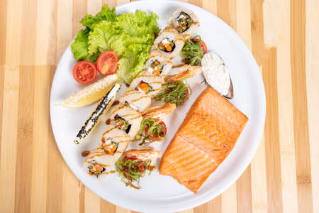 Assorted sushi, shrimp, and a piece of grilled salmon. For any purpose.の写真素材