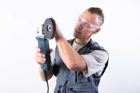 The builder in goggles, with an angle grinder in his hands. For any purpose.