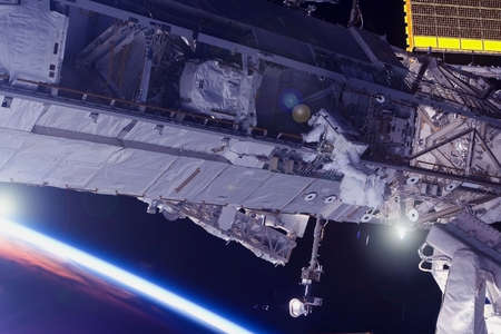 Astronaut at the space station is engaged in repairs.