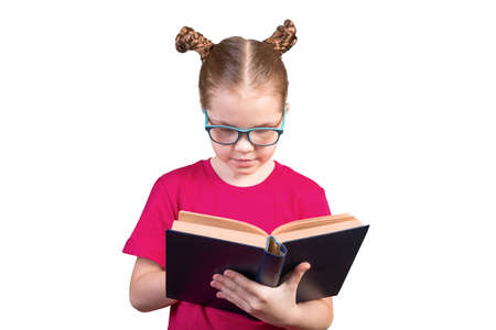 A girl with glasses is reading an old book. Isolated on a white background. For any purpose.