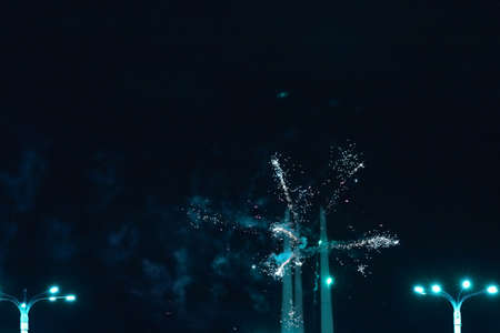 A simple firework with burning lanterns in the foreground.の写真素材