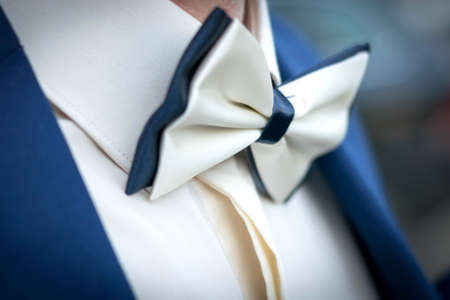 Men's bow tie, white with a blue suit. For any purpose.の写真素材