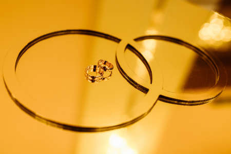 Wedding rings on a stand in gold tones. For any purpose.