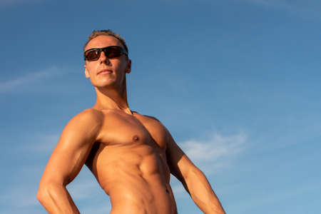 A muscular man in the sky. With the bared torso. For any purpose.