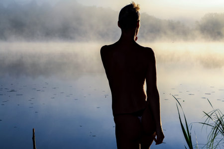 The woman on the lake, at dawn in the fog. For any purpose.の写真素材