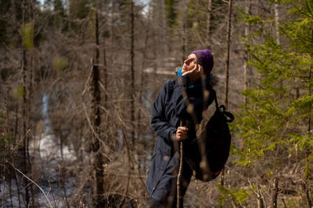 An adult woman wanders around the swamp. For any purpose.