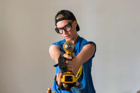 Woman builder with a drill in her hands For any purpose.の写真素材