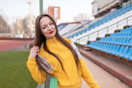Girl alone in an empty stadium.