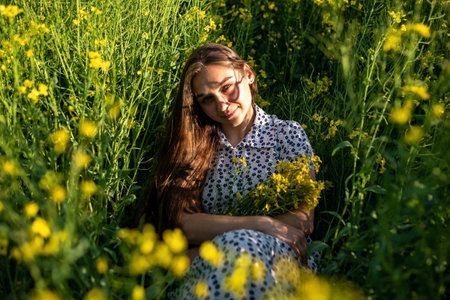 Girl in a rapeseed field in the sun. High quality photo
