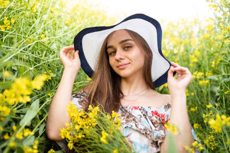 Minsk, Belarus - April 14, 2018 Girl in a dress in a rapeseed field. High quality photoのeditorial素材