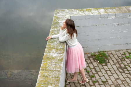 The girl on the beach dirty river. High quality photoの写真素材