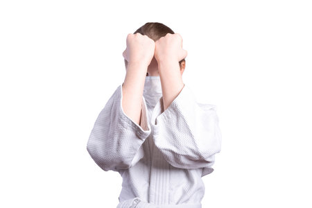 Girl in a kimono judo. In a fighting stance. Isolated on white background. High quality photoの写真素材