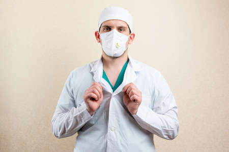 Doctor in goggles and a mask, on a light background. High quality photoの写真素材