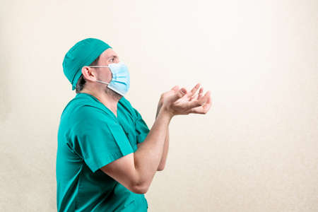 An indignant doctor in a cap and a mask.の写真素材