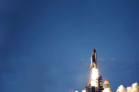 Launch of the space shuttle into space.