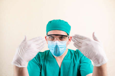 The doctor is wearing a mask and misted goggles.