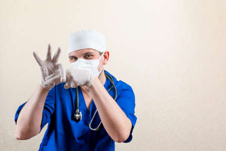 Urologist in mask and gloves. On a light background.の写真素材