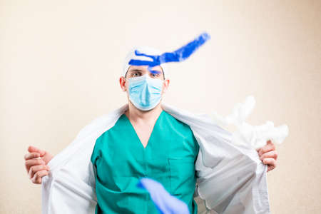 The doctor plays and throws up his gloves. On a light background.の写真素材