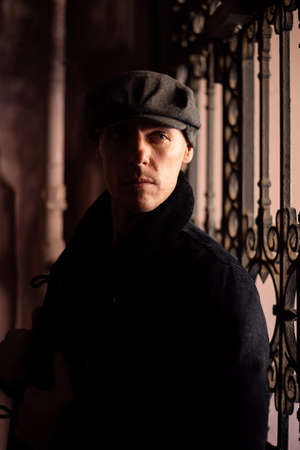 A man in a coat and cap walks around the city. High quality photo