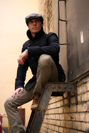 A man in a coat and cap walks around the city. High quality photoの写真素材