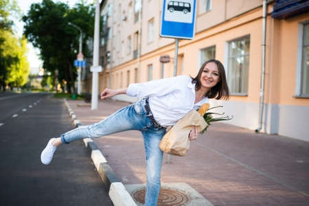 Beautiful girl with a paper bag with groceries. High quality photo