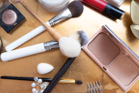Cosmetics and makeup brushes, on the table. high quality photo