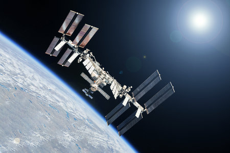 ISS over the planet, against the background of clouds.