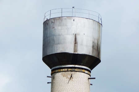 Old brick water tower against the sky. high quality photo