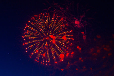 Bright, beautiful red fireworks in the night sky. high quality photoの写真素材