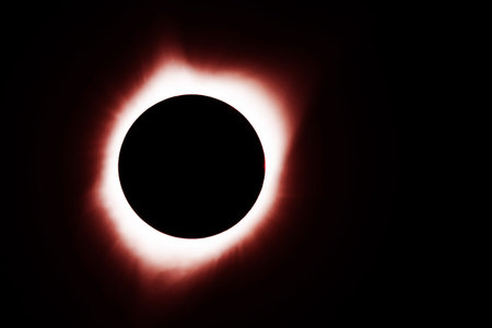 A solar eclipse on a dark background.の写真素材