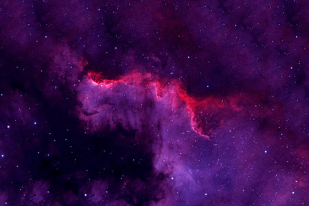 Purple and red space nebula with stars against dark cosmic backgroundの写真素材