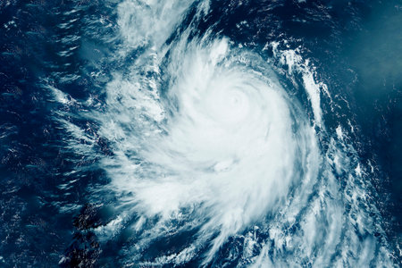Hurricane viewed from space showing spiral cloud formation over oceanの写真素材
