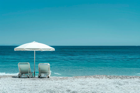 Two sun loungers under an umbrella on the beach. Generative AIの素材