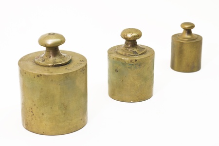 Three antique weights isolated on whiteの写真素材