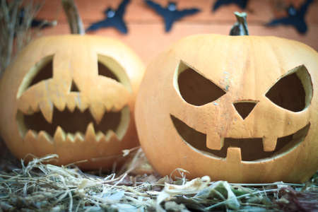 Two different Halloween pumpkins on autumn background, candles turn offの写真素材
