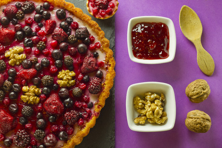 Autumn fruits cakes and ingredients on purple backgroundの写真素材