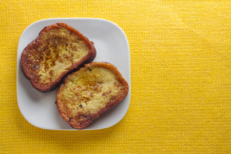 Spanish Torrijas on yellow background