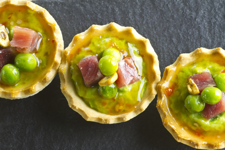 Peas with ham and garlic tapa on a slate plateの写真素材