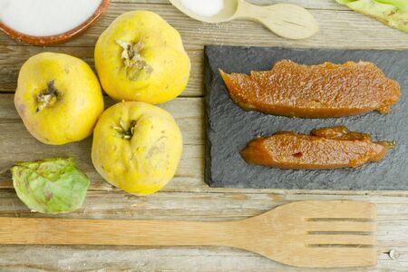 Spanish quince fruits and paste with ingredients on wooden backgroundの写真素材