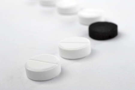 White and black tablets on white background.
