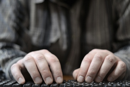Hands on the keyboard - abstract computer background.の写真素材