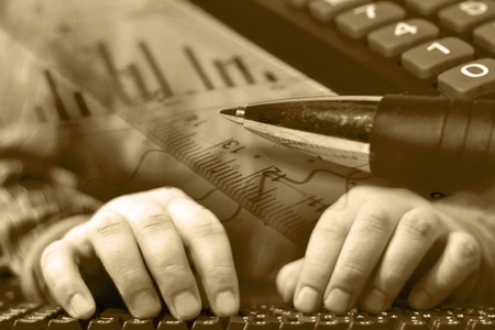 Business background with graph, ruler, pen and calculator, in sepia.の写真素材