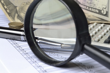 Business background with magnifier, pen and money.の写真素材