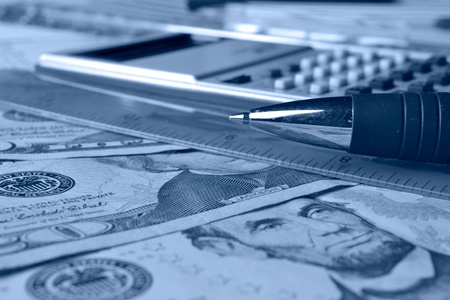 Business background with table, coins and pen.の写真素材
