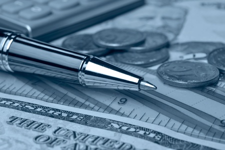 Business background in blues with money, coins and pen.の写真素材
