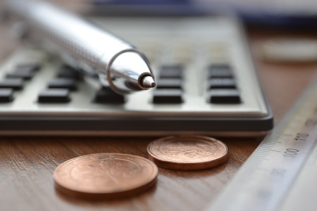 Business background with money, calculator and pen.