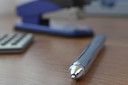 Office background with graph, ruler, pen and stapler.