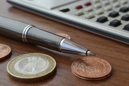 Financial background with money, calculator, table and pen.
