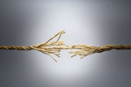 Broken rope on dark background.の写真素材